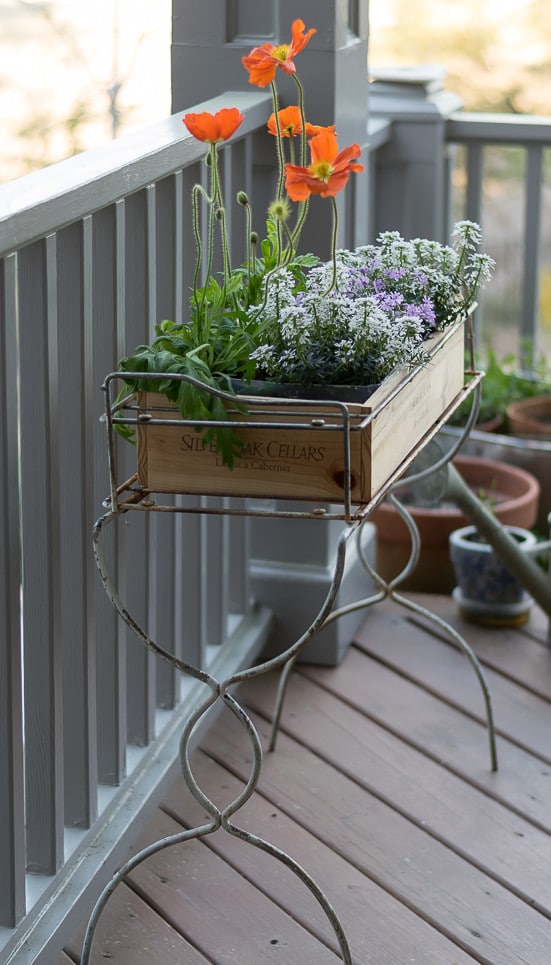 What a great upcycle and repurpose! A wooden wine crate makes a great planter for a container garden.. An easy DIY for porch decor.