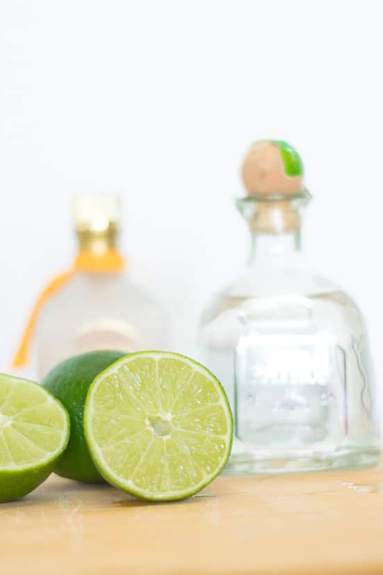 The perfect margarita recipe: limes with tequila bottle