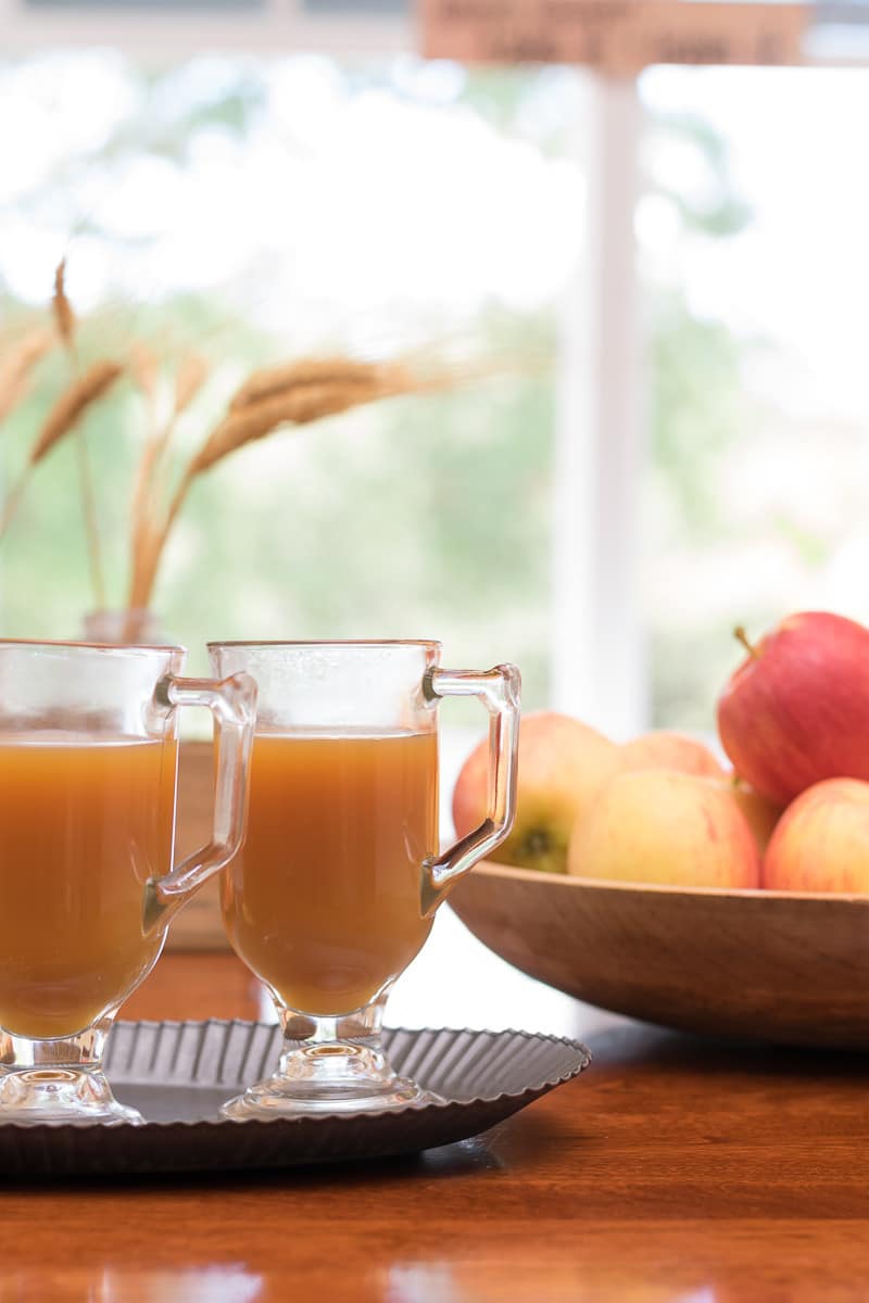 This spiked warm caramel apple cider is like a cup of fall! Perfect adult hot apple cider drink recipe for tailgating, entertaining or sipping around the fire on a cool fall evening