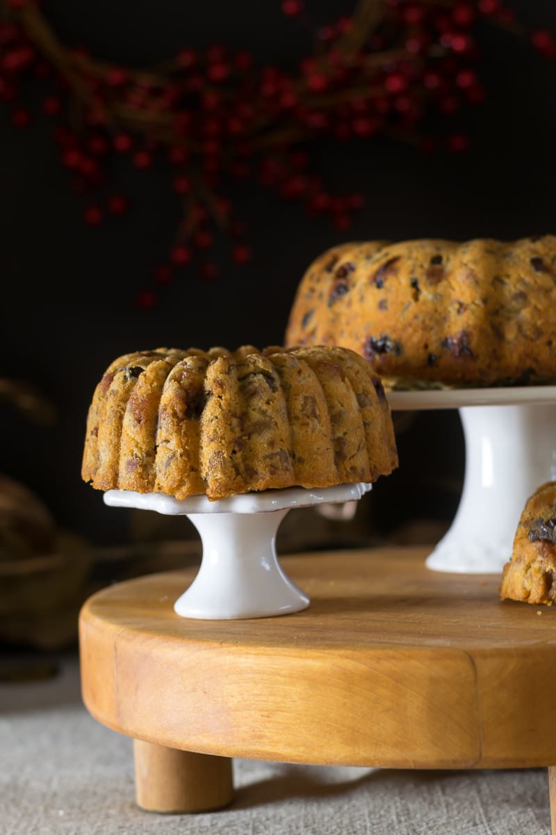Holiday Baking planner and recipes: finished white fruitcakes on a stand 
