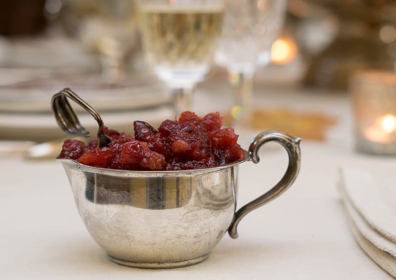Cranberry relish with antique baby spoon on Thanksgiving table