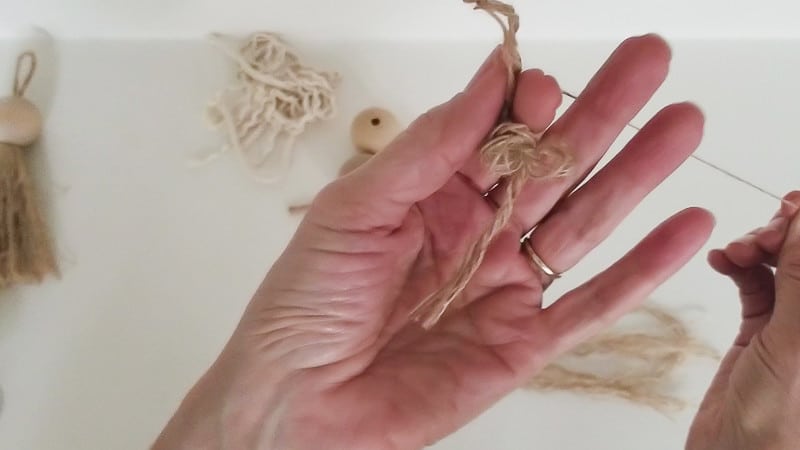 Pulling threads from jute rope for decorative tassel